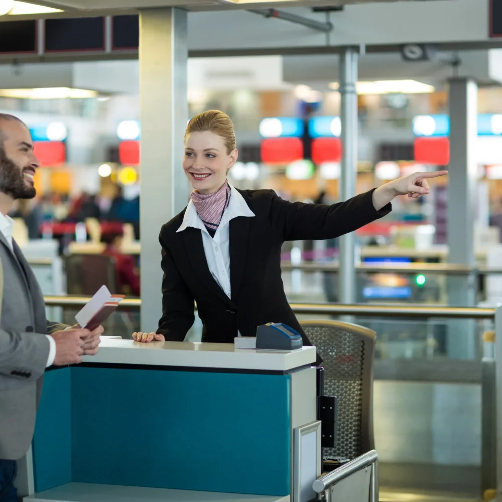 airline-check-attendant-showing-direction-commuter-check-counter